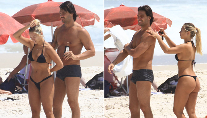  Gustavo Mendonça, irmão gêmeo de Flávio, curte praia com loira 