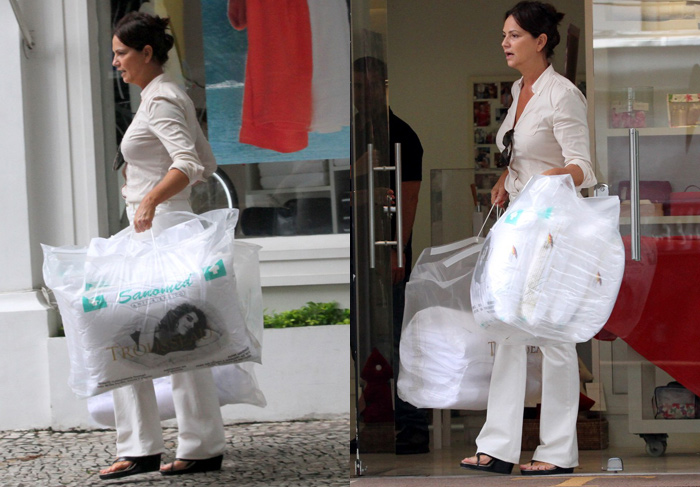 Luiza Brunet sai carregada de sacolas em liquidação de loja