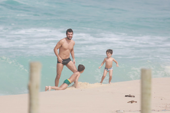 Daniel de Oliveira se diverte com os filhos enquanto malha na praia da Reserva, no Rio 