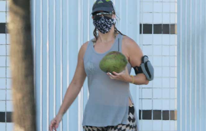 Christine Fernandes tomou água de coco durante seu dia na praia