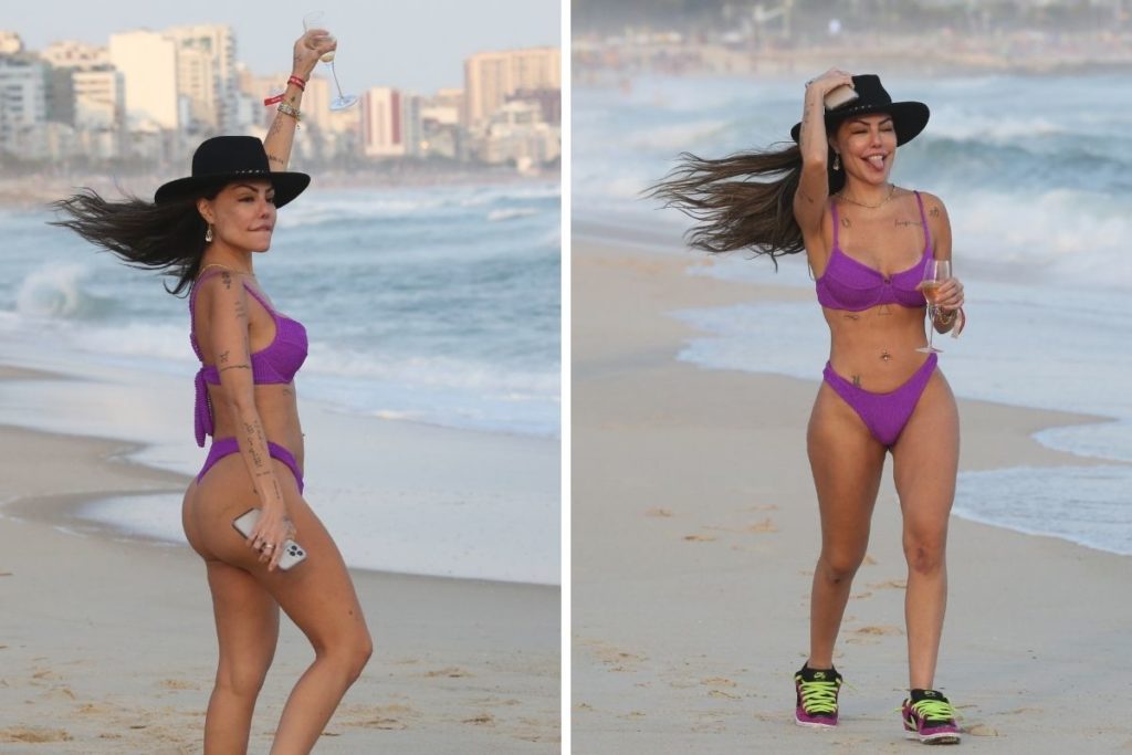 Liziane Gutierrez curte praia e toma espumante a beira mar