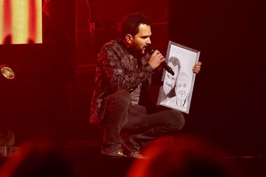 luciano camargo mostrando quadro do pai em show para vacinados