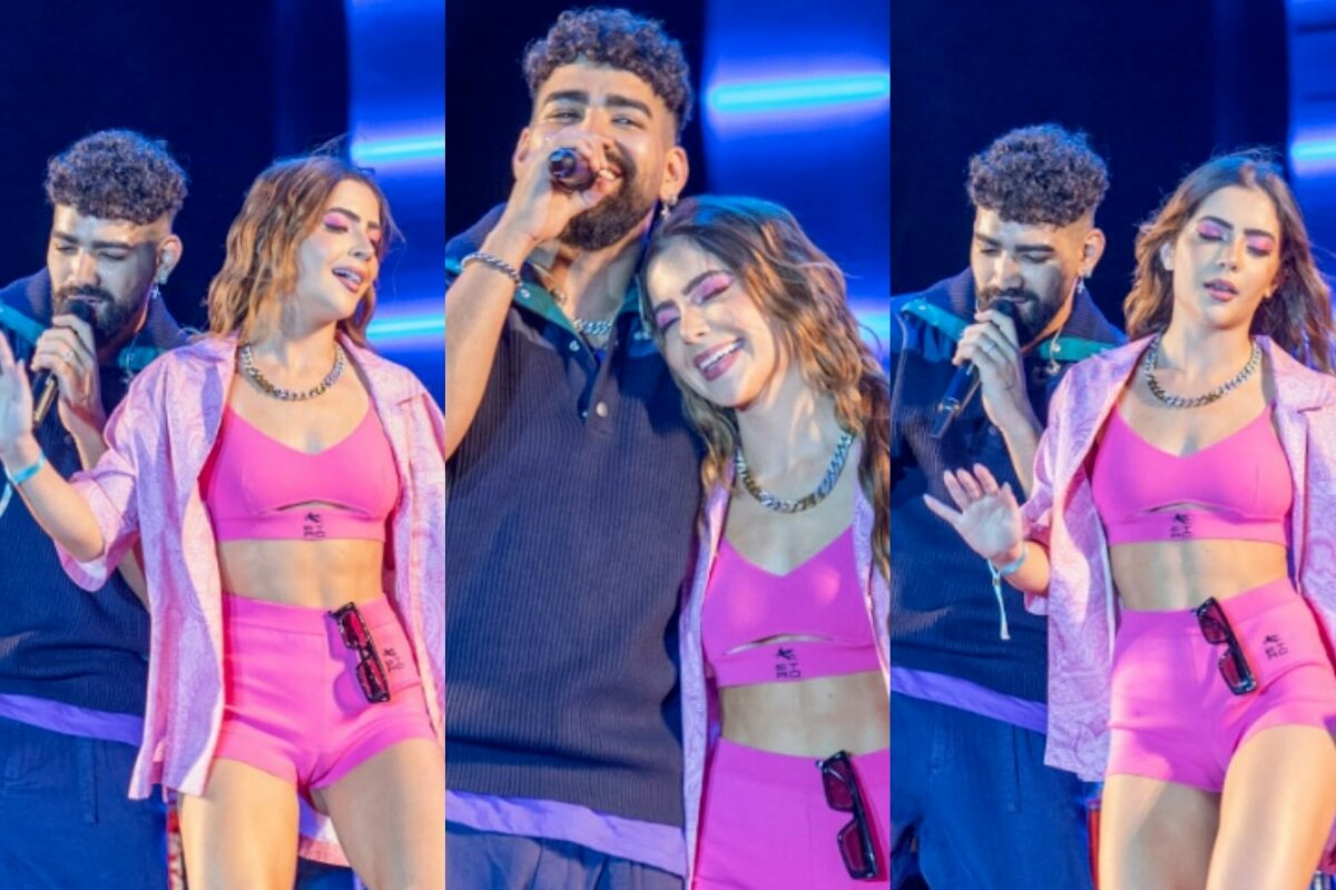 Jade Picon de short e cropped rosa, no palco com o cantor Dilsinho