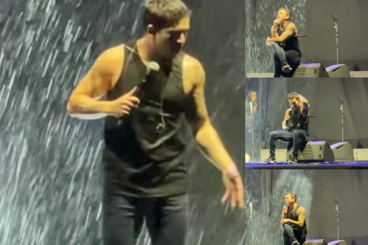 Whindersson Nunes de camiseta preta e calça preta, no palco, na chuva