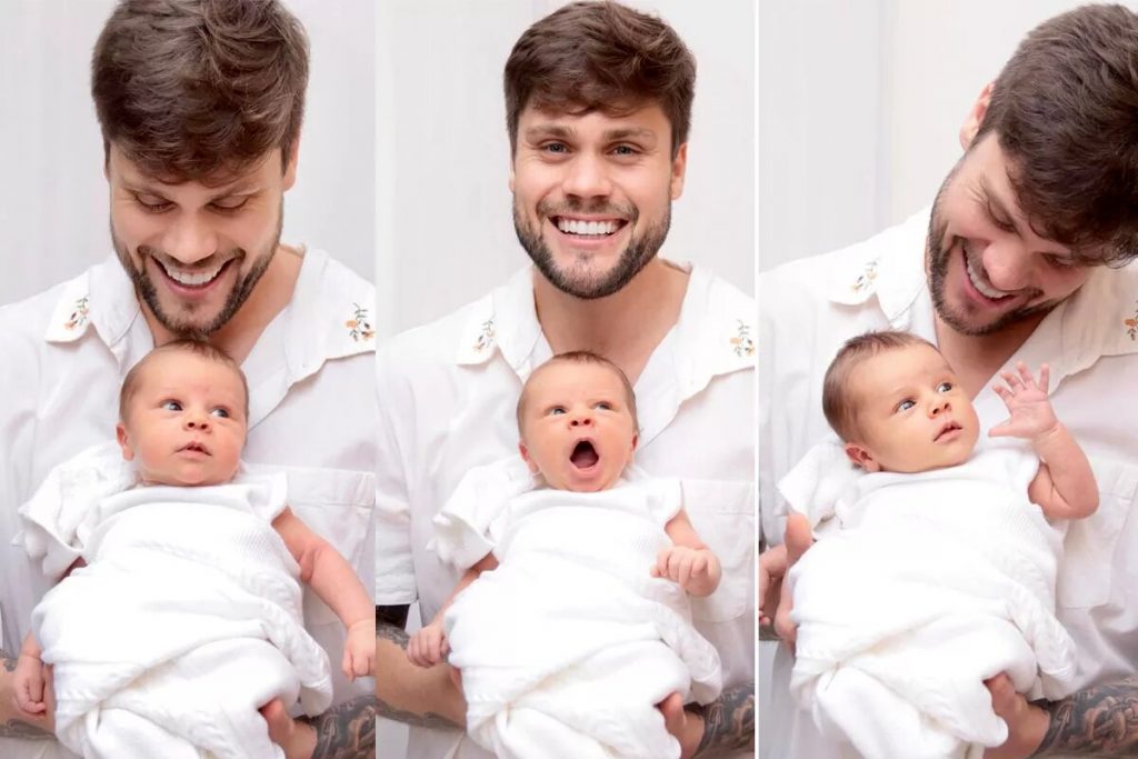 Breno Simões e Theo no colo, os dois de branco