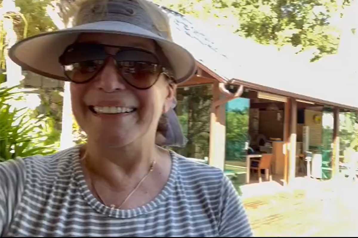 Susana Vieira de óculos de sol, sorridente, após alta hospitalar
