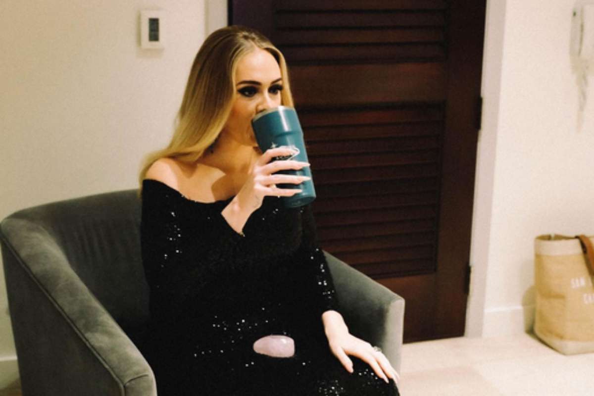 Adele tomando água no camarim