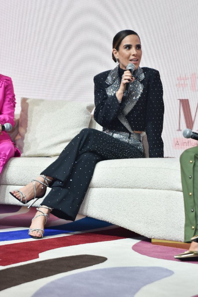 Wanessa sentada, falando ao microfone 