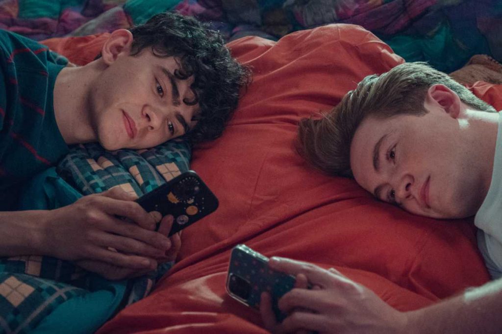 charlie (joe locke) e nick (kit connor) usando celular em heartstopper