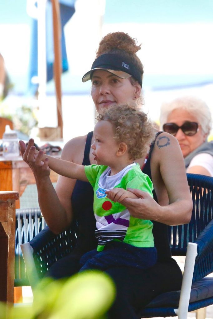 Fabiula Nascimento com um dos gêmeos em um quiosque
