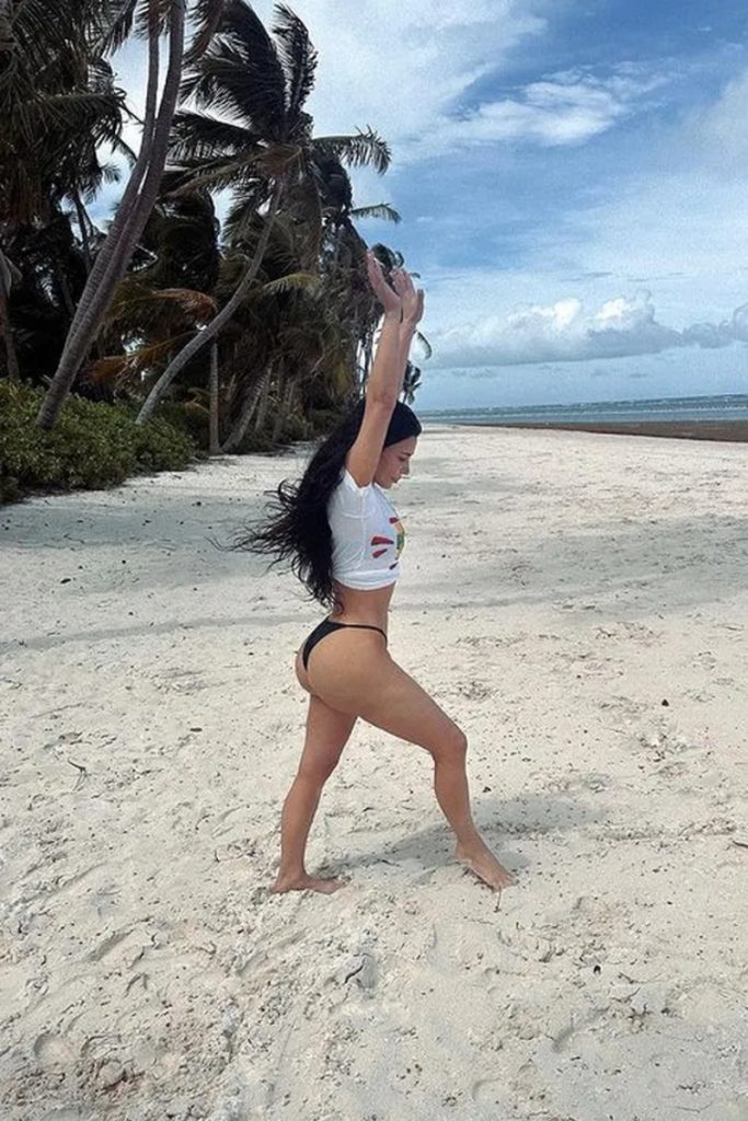 Kim Kardashian de camisa branca e biquíni preto