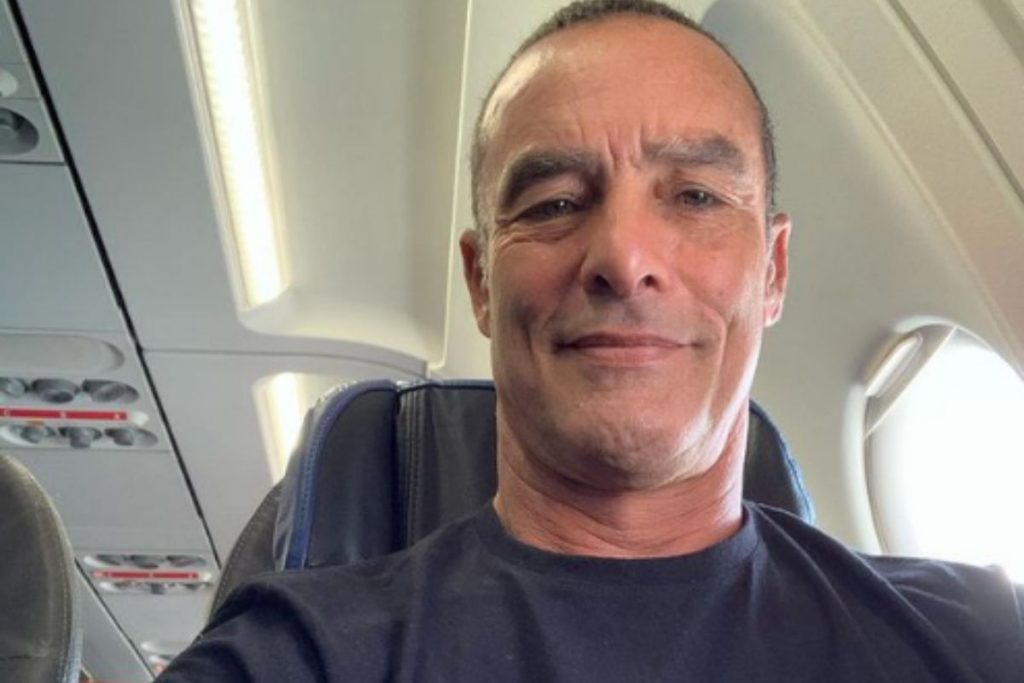 Paulo Zulu, sorrindo, dentro de um avião