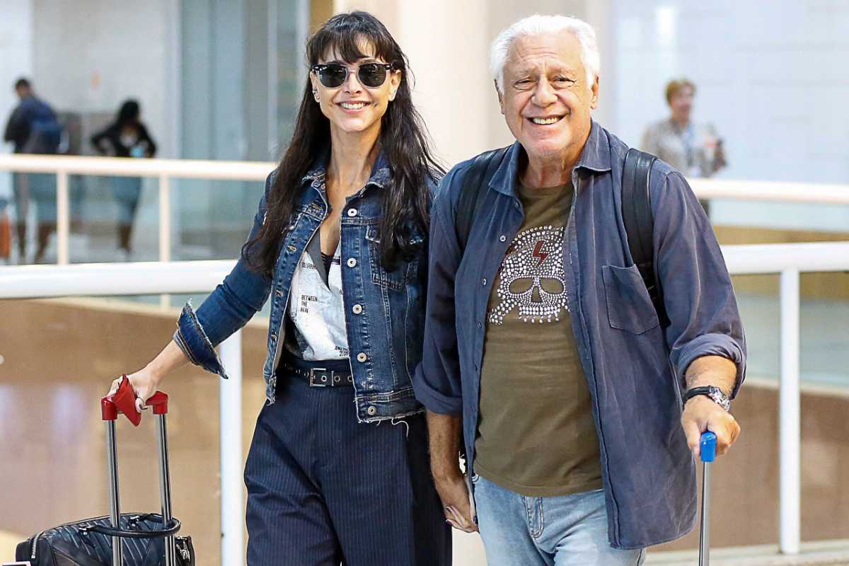 Antônio Fagundes e Alexandra Martins embarcando de mãos dadas no aeroporto Santos Dumont