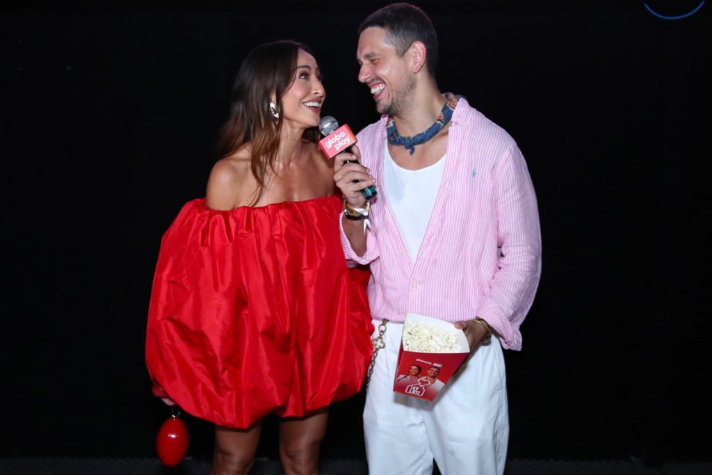 João Vicente de camisa rosa, calça branca, com e  Sabrina Sato de vestido vermelho tomara que caia, em forma de coração 